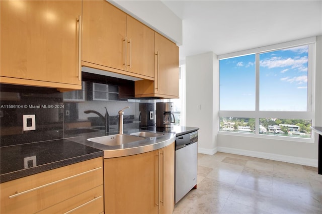 kitchen featuring dishwasher, decorative backsplash, sink, and light brown cabinetry