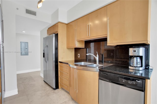 kitchen featuring sink, tasteful backsplash, light tile patterned flooring, appliances with stainless steel finishes, and light brown cabinetry