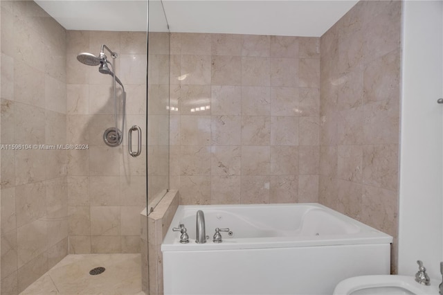 bathroom featuring a bidet and separate shower and tub