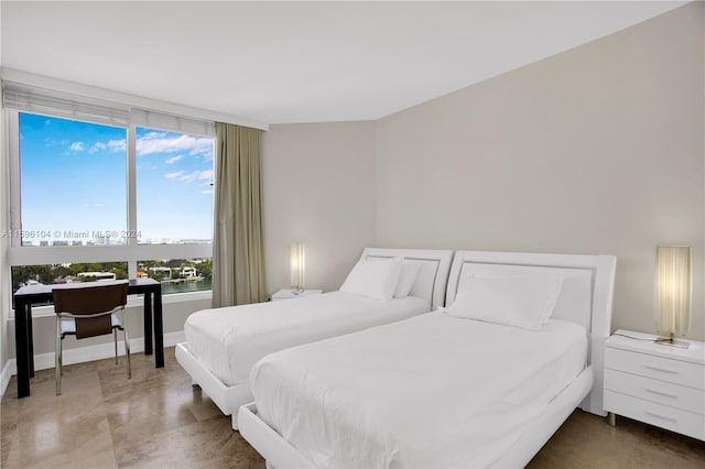 bedroom featuring a water view