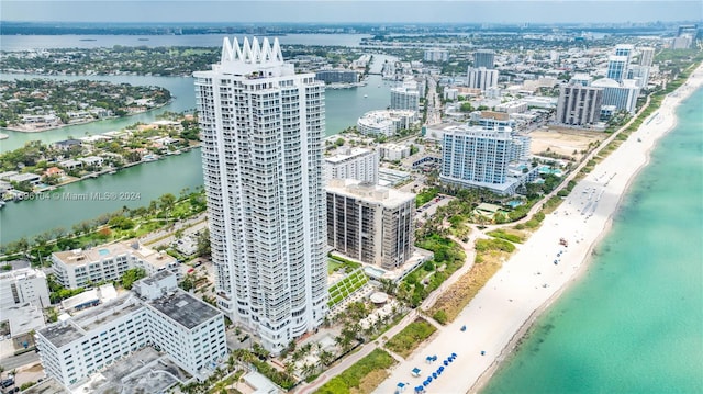 drone / aerial view with a beach view and a water view