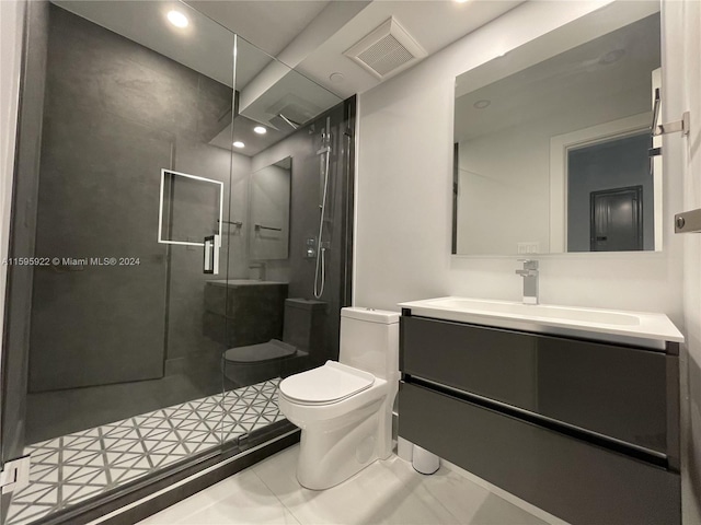 bathroom featuring tile patterned flooring, vanity, toilet, and a shower with door