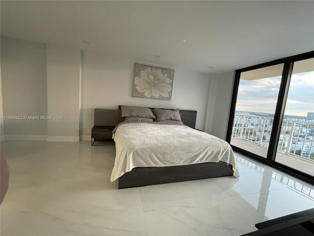 bedroom featuring access to exterior and floor to ceiling windows