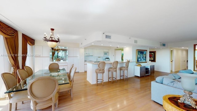 interior space featuring a notable chandelier and light wood-type flooring