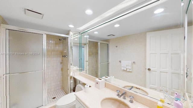 bathroom featuring tile patterned flooring, vanity, and a shower with shower door