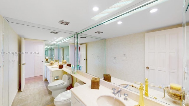 bathroom featuring hardwood / wood-style flooring, vanity, and toilet