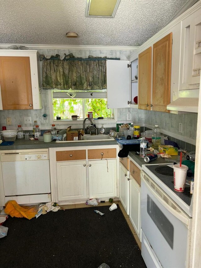 kitchen featuring white appliances, a textured ceiling, backsplash, wall chimney range hood, and sink