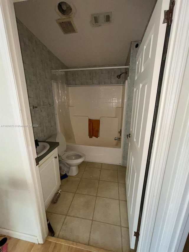 bathroom featuring tile patterned floors, visible vents, toilet, shower / bath combination, and vanity