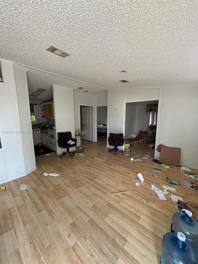 interior space with visible vents, a textured ceiling, and light wood-style flooring
