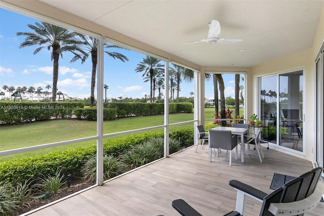 sunroom featuring ceiling fan