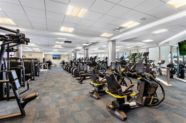 workout area with carpet floors and a drop ceiling