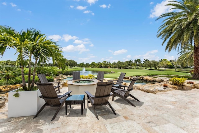 view of patio featuring a water view and a fire pit