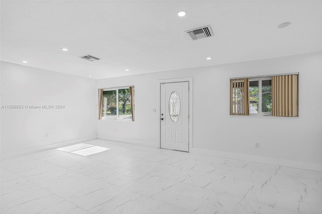 unfurnished room featuring plenty of natural light