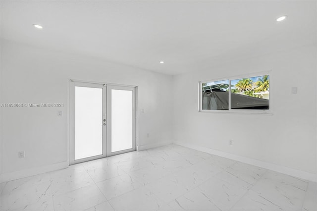 spare room featuring french doors