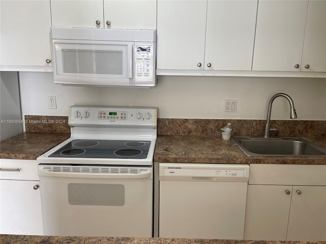 kitchen with sink, white cabinetry, and white appliances