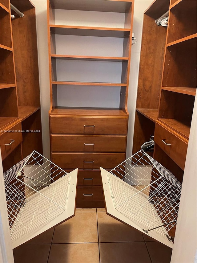 spacious closet with light tile floors