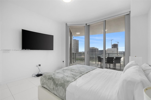 tiled bedroom featuring access to outside and a wall of windows