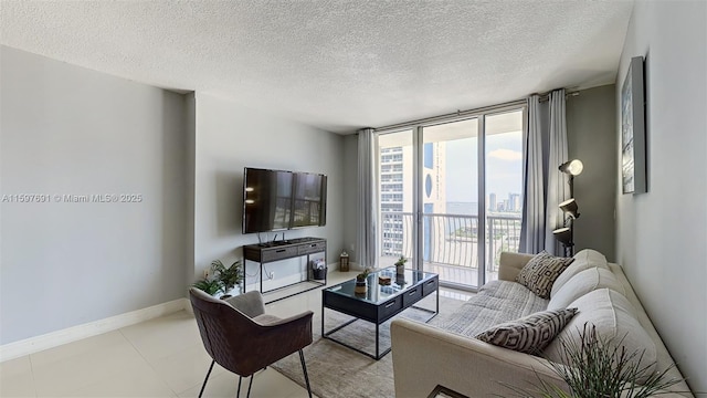 living area featuring floor to ceiling windows, baseboards, and a textured ceiling