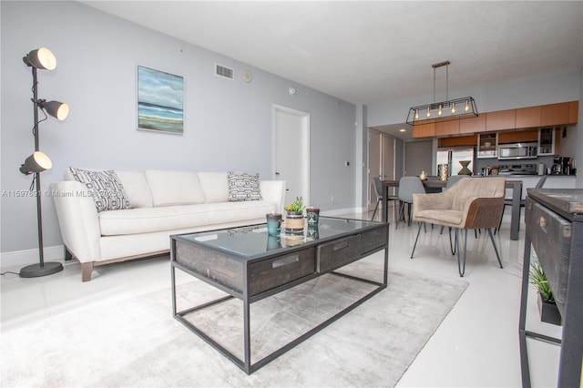 living room featuring baseboards and visible vents