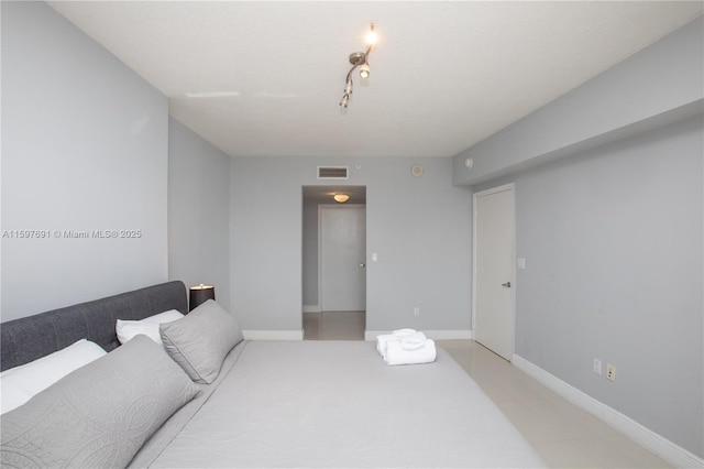 bedroom featuring visible vents and baseboards