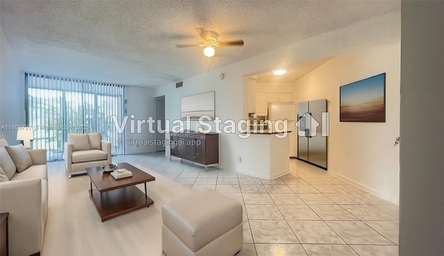 tiled living room with a textured ceiling and ceiling fan