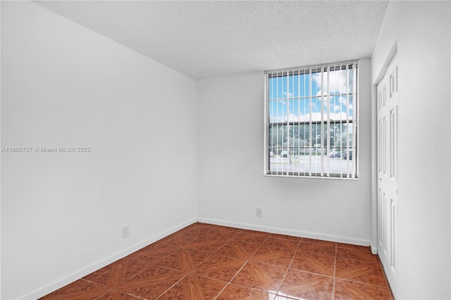 empty room featuring a textured ceiling