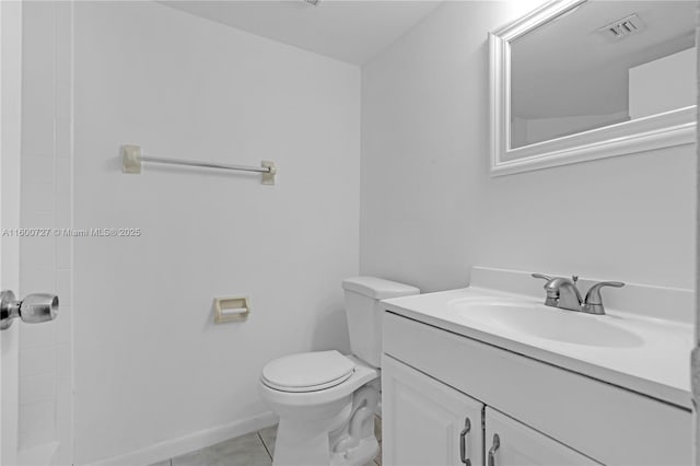 bathroom with tile patterned floors, vanity, and toilet