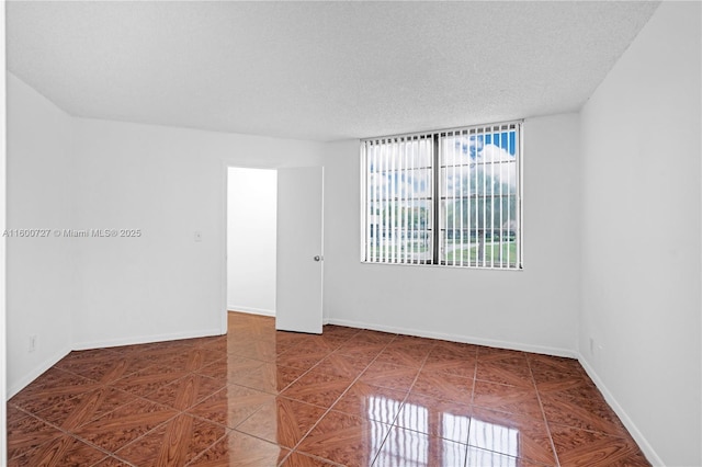 empty room featuring a textured ceiling