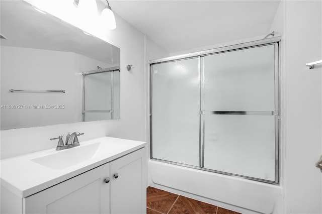 bathroom featuring bath / shower combo with glass door and vanity