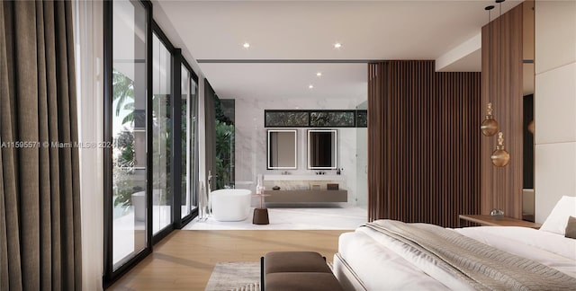 bedroom featuring access to exterior, light wood-type flooring, and floor to ceiling windows