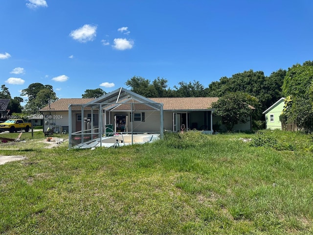 rear view of property with a patio area and a lanai