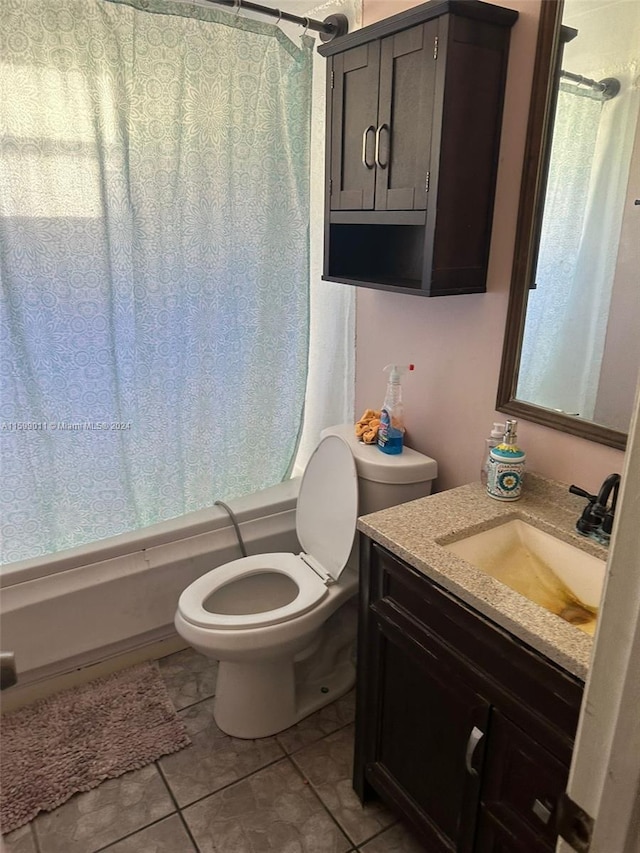 full bathroom with tile patterned floors, vanity, shower / tub combo, and toilet