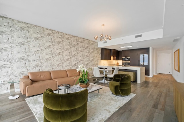 living room featuring hardwood / wood-style floors and a chandelier