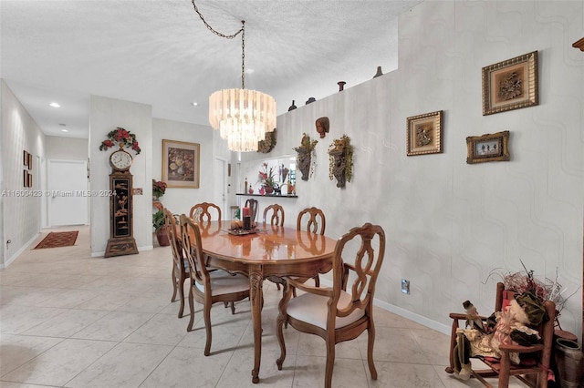 dining area with light tile patterned floors, a chandelier, and a textured ceiling