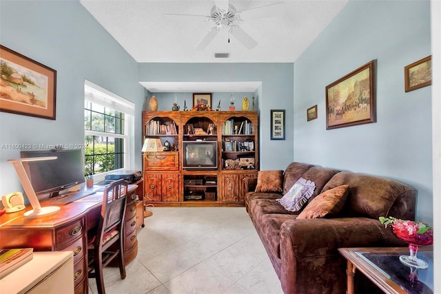 tiled home office featuring ceiling fan and a textured ceiling