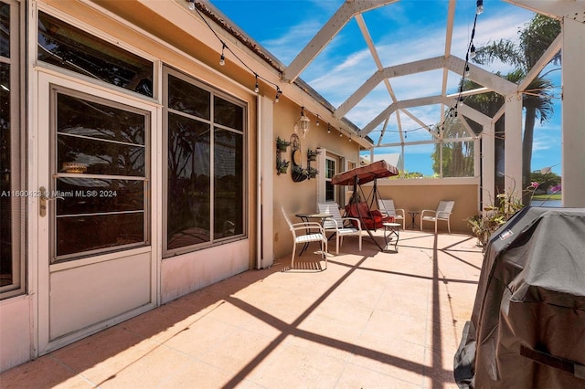 view of patio / terrace featuring glass enclosure