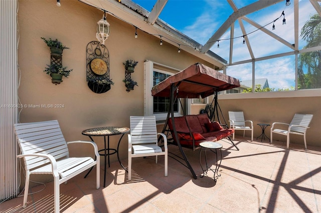 view of patio / terrace featuring a lanai