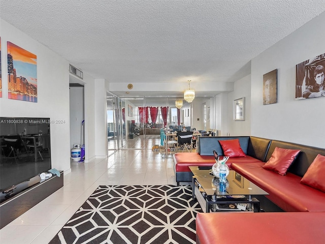 living room featuring tile patterned floors, a chandelier, and a textured ceiling