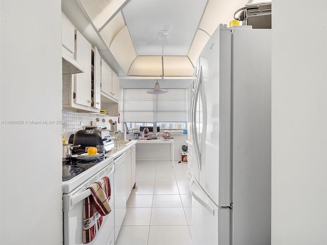 kitchen featuring tasteful backsplash, white appliances, white cabinets, hanging light fixtures, and light tile patterned flooring