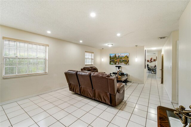 tiled living room with a textured ceiling