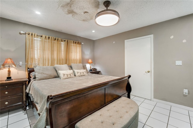 bedroom featuring a textured ceiling, ceiling fan, and light tile floors