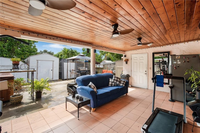 view of patio / terrace with ceiling fan, grilling area, a shed, an outdoor hangout area, and a gazebo