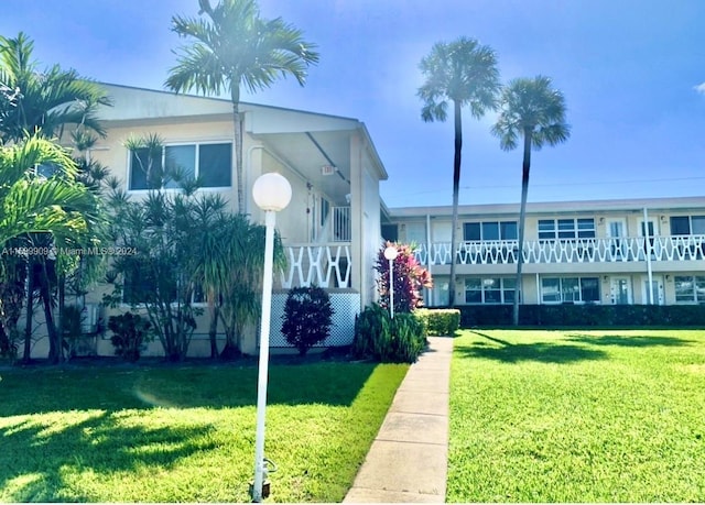 view of front of home with stucco siding and a front yard