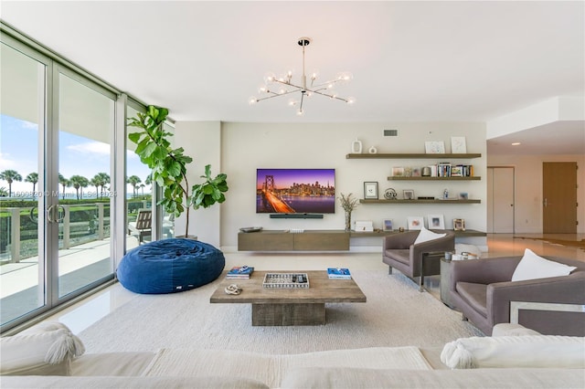 living room with a notable chandelier and a wall of windows