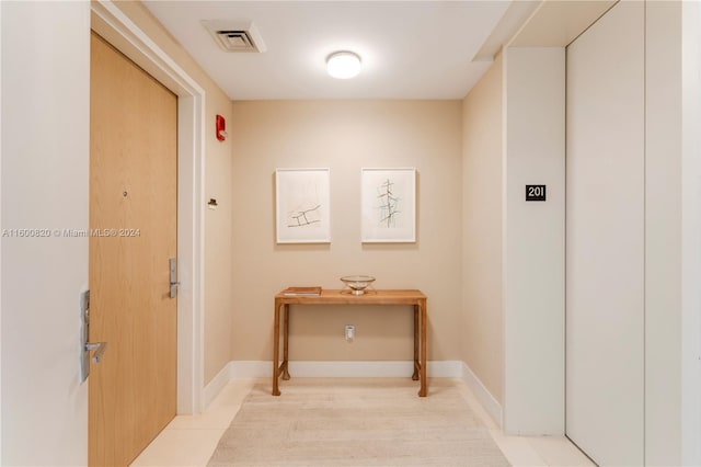 hallway with light tile floors