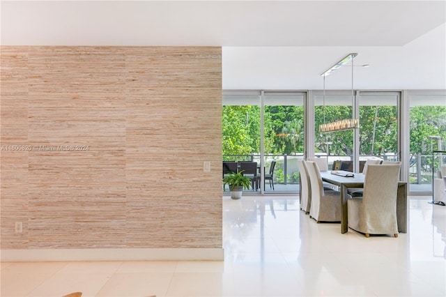 unfurnished dining area with light tile floors and expansive windows