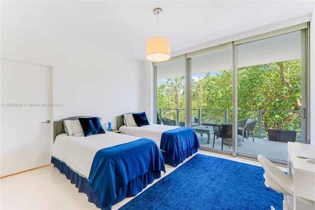 tiled bedroom with a wall of windows and access to exterior