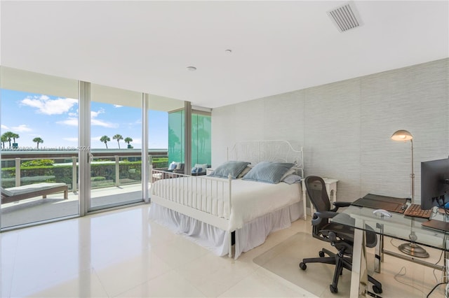 tiled bedroom with multiple windows, expansive windows, and access to outside