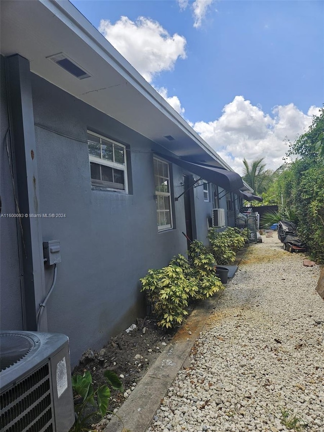 view of property exterior with cooling unit and stucco siding