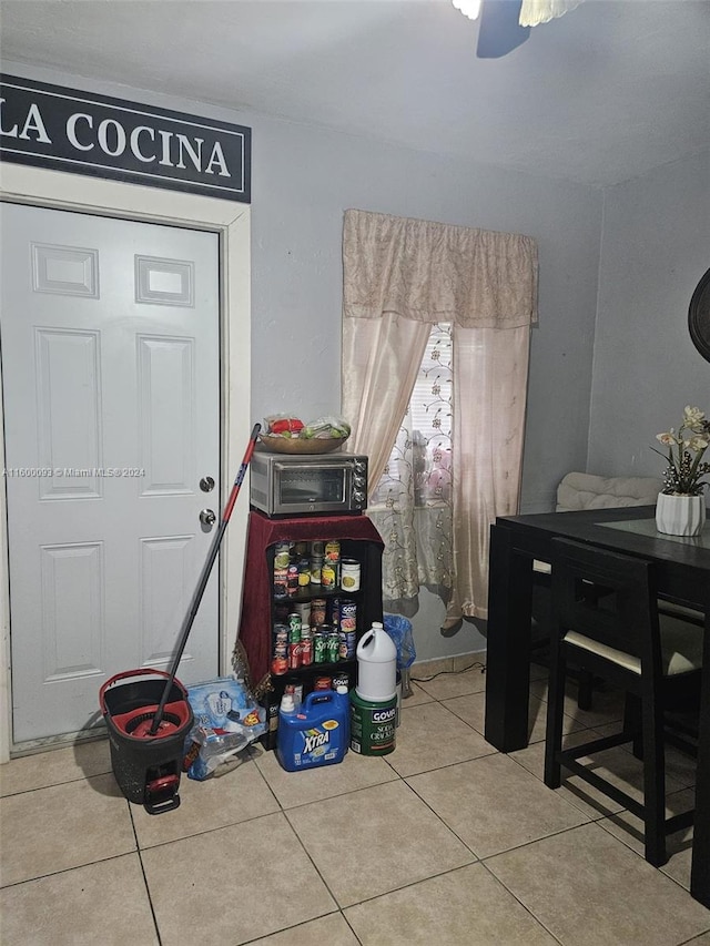dining area with tile patterned floors and ceiling fan